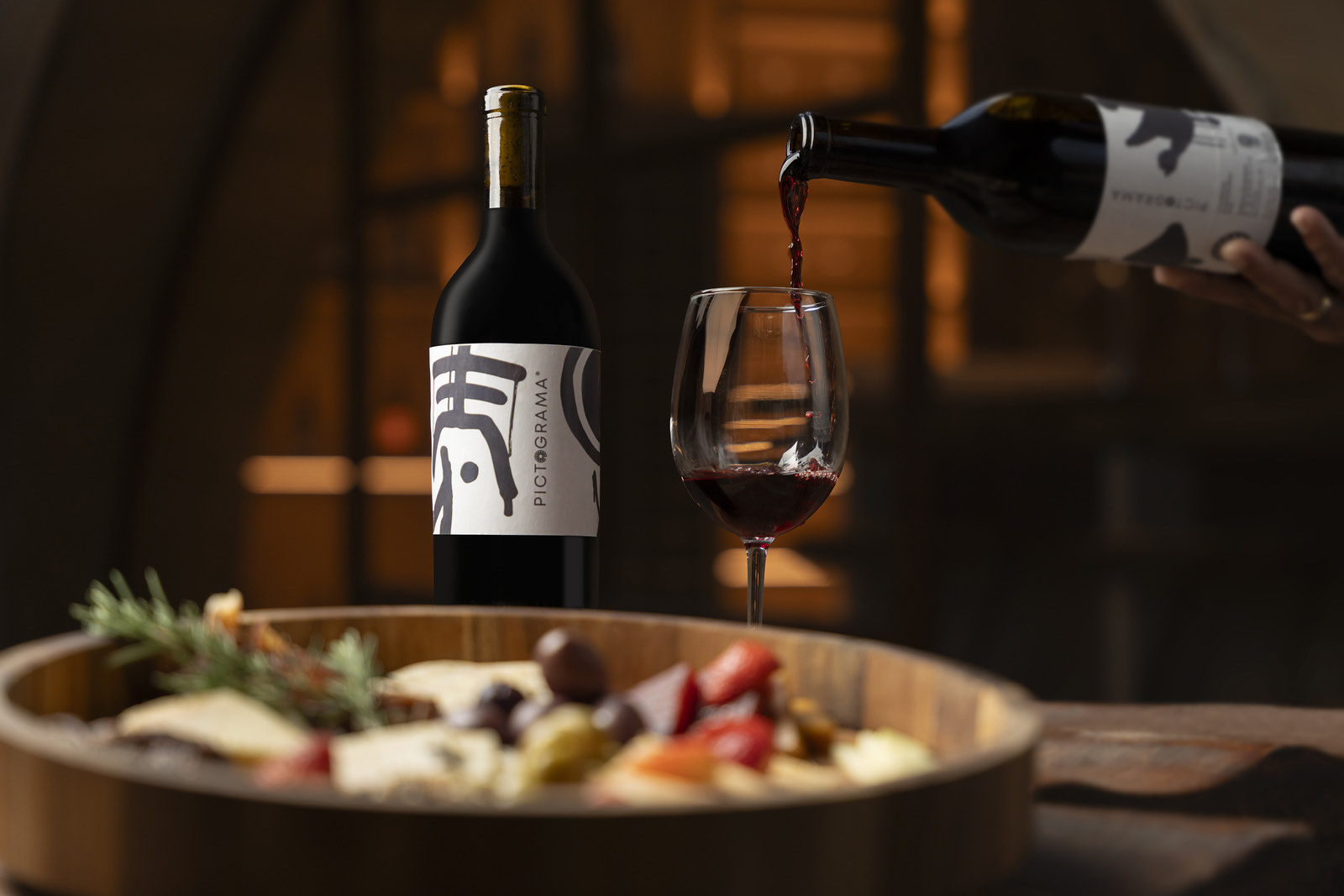 Vino tinto servido junto a tabla de quesos