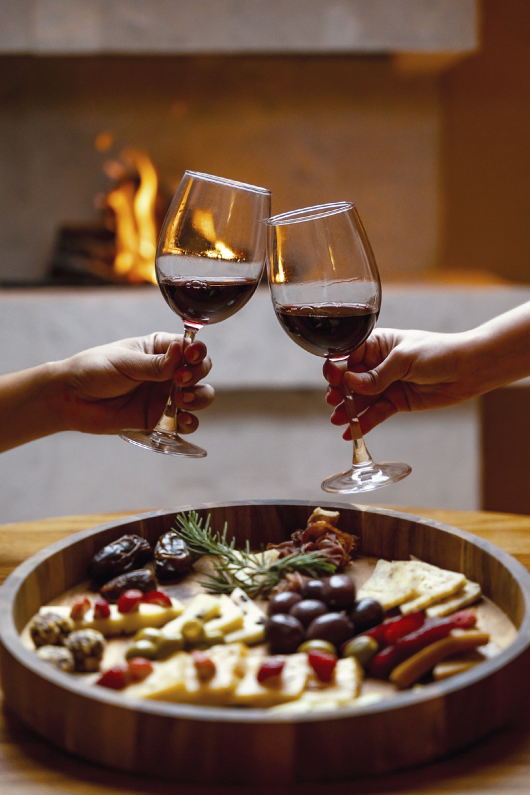 Brindis con vino tinto frente a la chimenea